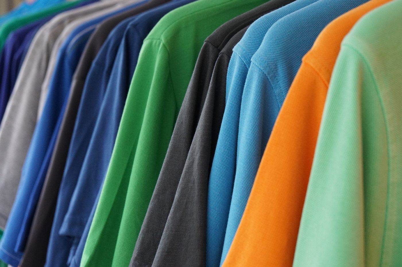 Colourful polo shirts on rack